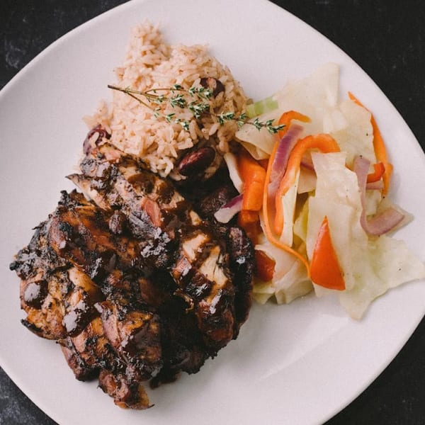 Jammin Island BBQ jerk chicken with rice and peas, and a side of steamed cabbage.